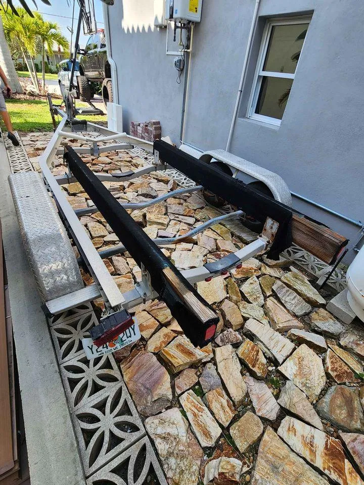 Slide: The Image of Boat trailer for 1976 Boston Whaler 17 Montauk on stone driveway. - 7