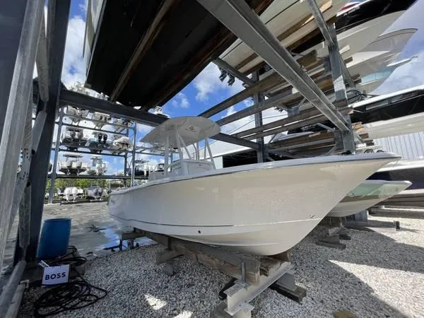 The Image of 2022 Sea Hunt Ultra 229 boat stored in a dry dock facility. - 0