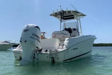 Slide: The Image of 2014 Wellcraft 252 Fisherman boat with Yamaha outboard motor in clear water. - 2