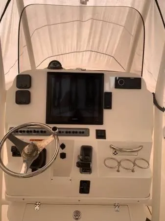 Slide: The Image of 2014 Wellcraft 252 Fisherman boat console with steering wheel and navigation screen. - 3