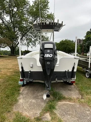 Slide: The Image of 2012 Onslow Bay 20 boat with 150 HP engine, parked on grass. - 3