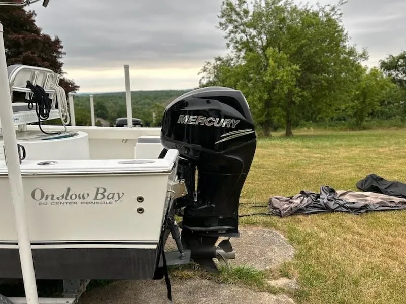 Slide: The Image of 2012 Onslow Bay 20 boat with Mercury outboard motor on grassy area. - 4