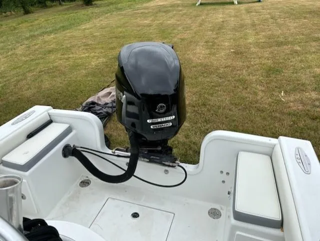 Slide: The Image of 2012 Onslow Bay 20 boat with outboard motor on grassy area. - 6