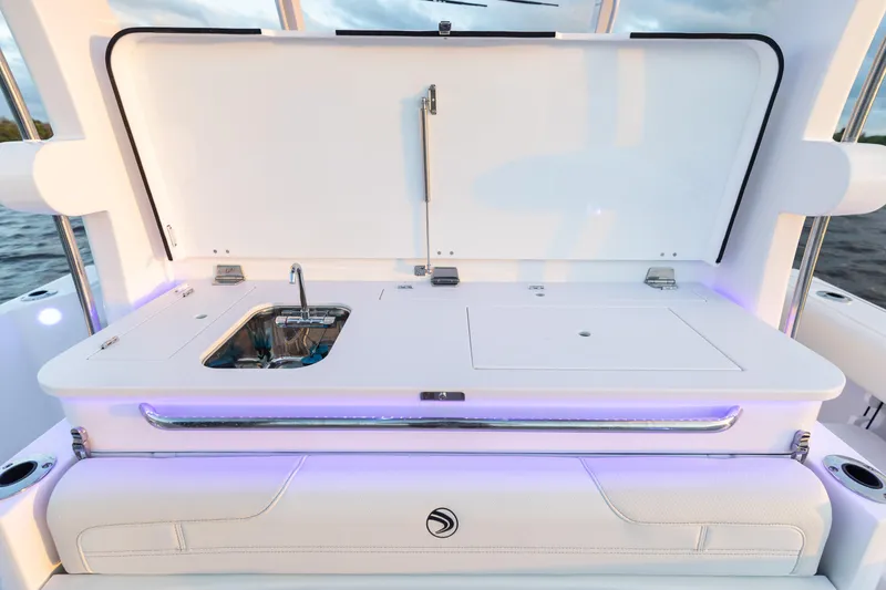 Slide: The Image of 2024 Edgewater 370CC boat with open deck storage and sink. - 15