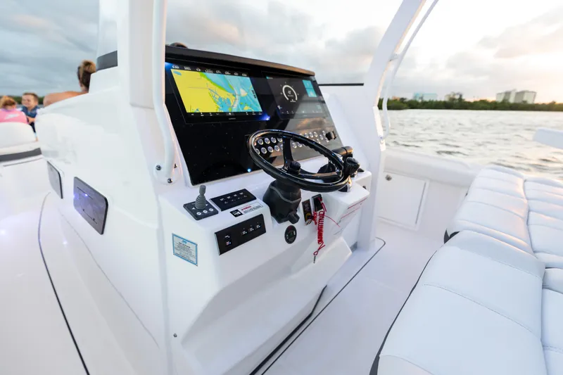 Slide: The Image of 2024 Edgewater 370CC boat helm with navigation system and steering wheel. - 18