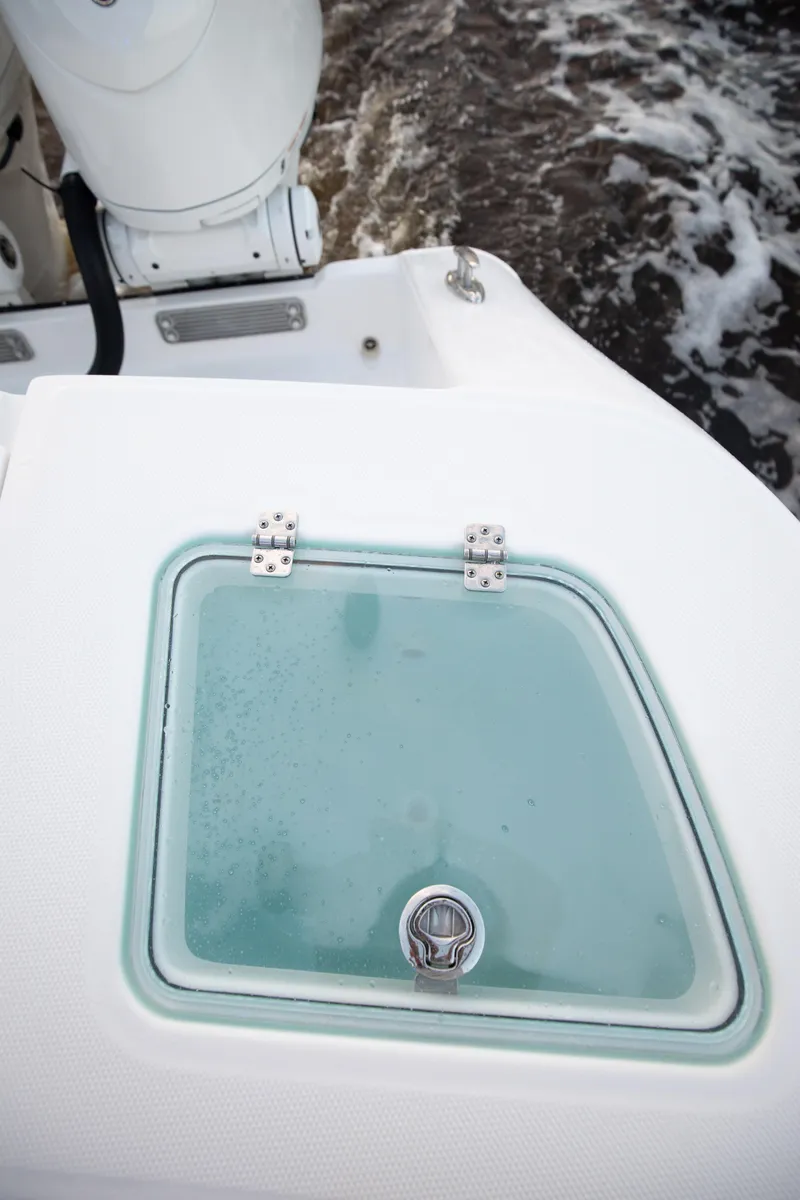 Slide: The Image of 2024 Edgewater 370CC boat livewell with water in the background. - 24