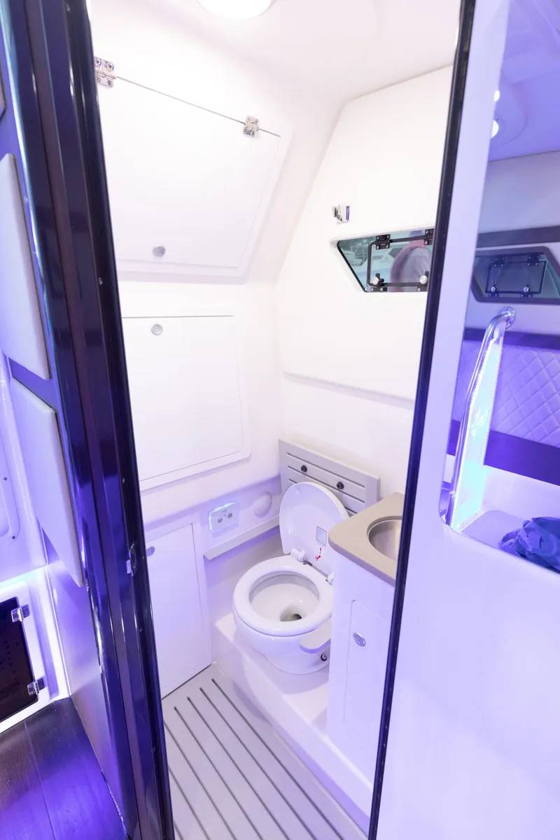 Slide: The Image of 2024 Edgewater 370CC boat interior bathroom with modern fixtures and lighting. - 30