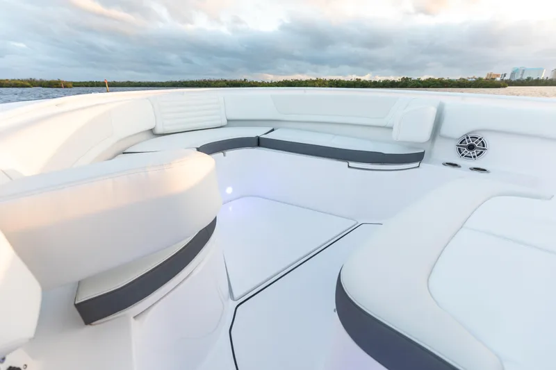 Slide: The Image of 2024 Edgewater 370CC boat with spacious white seating area and scenic water view. - 8