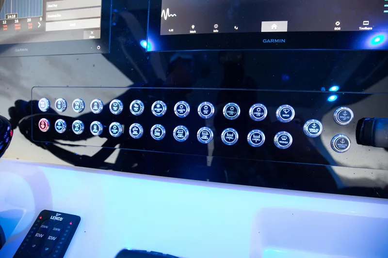 Slide: The Image of Control panel of 2024 Edgewater 370CC boat with illuminated buttons and Garmin display. - 9