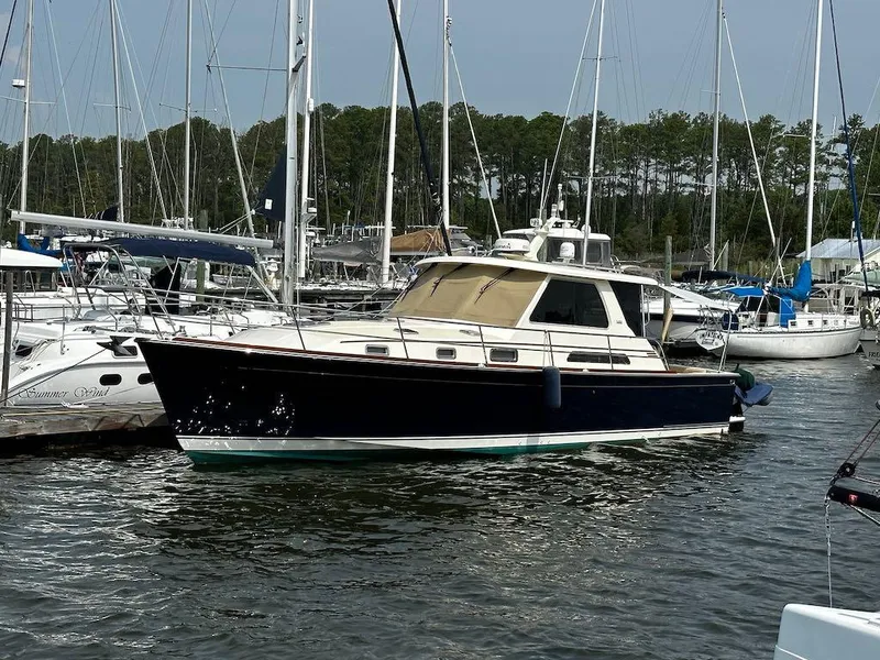 Slide: The Image of 2008 Sabre 42 Hard Top Express yacht docked in a marina. - 0