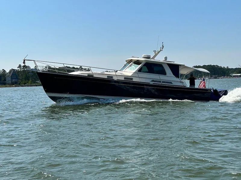 Slide: The Image of 2008 Sabre 42 Hard Top Express cruising on a sunny day, American flag displayed. - 1
