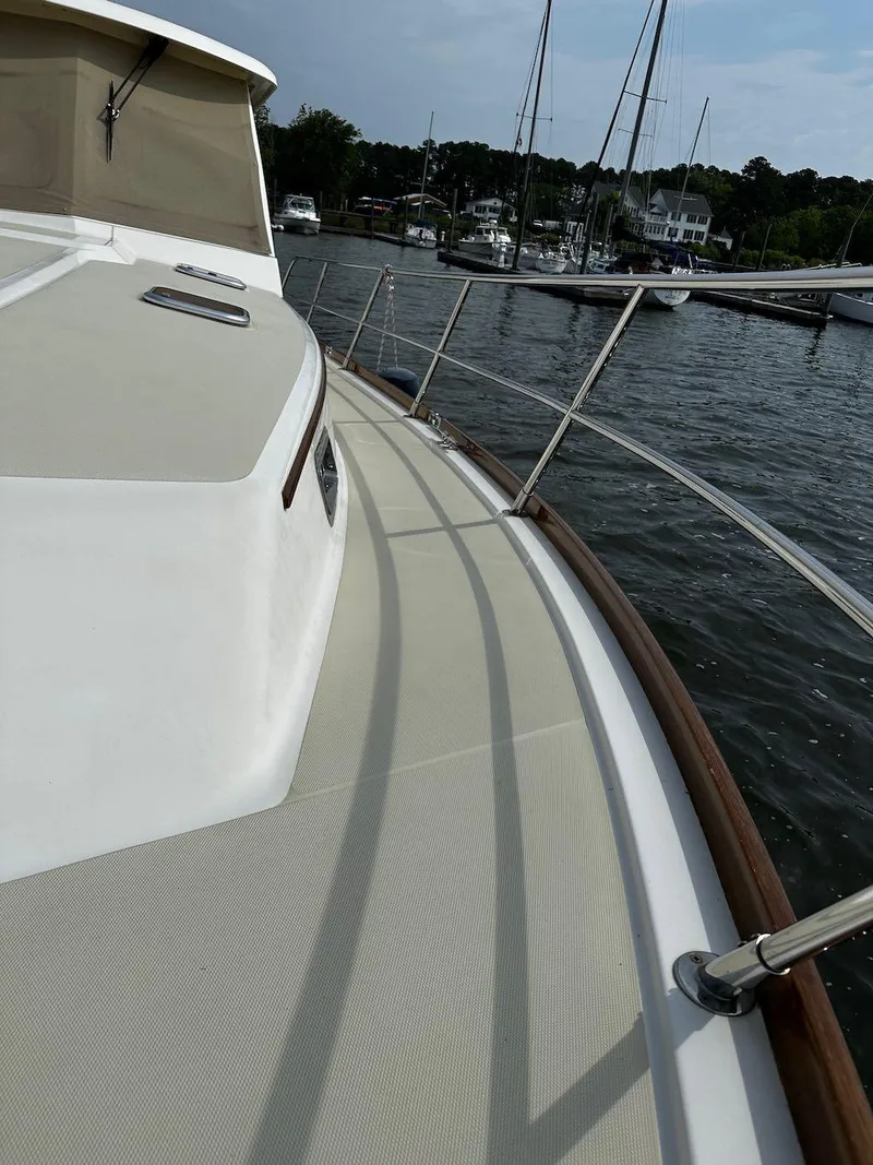 Slide: The Image of 2008 Sabre 42 Hard Top Express yacht deck with railing, docked in a marina. - 10