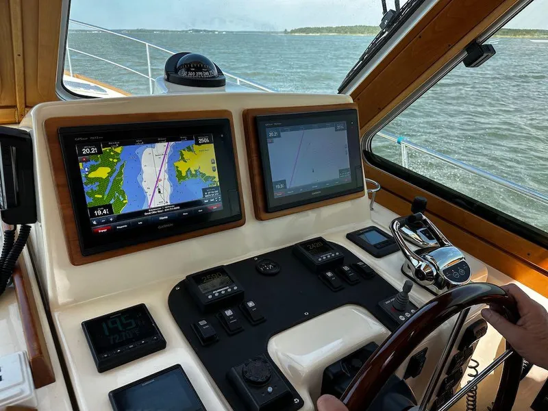 Slide: The Image of 2008 Sabre 42 Hard Top Express helm with navigation screens and controls on open water. - 14