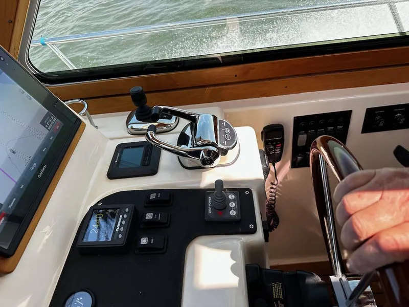 Slide: The Image of Control panel of 2008 Sabre 42 Hard Top Express boat with steering wheel and navigation equipment. - 18