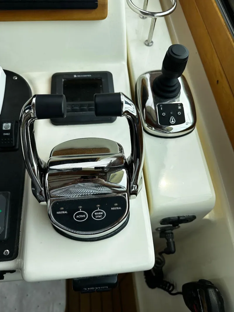 Slide: The Image of Control panel of 2008 Sabre 42 Hard Top Express yacht with throttle and joystick. - 19