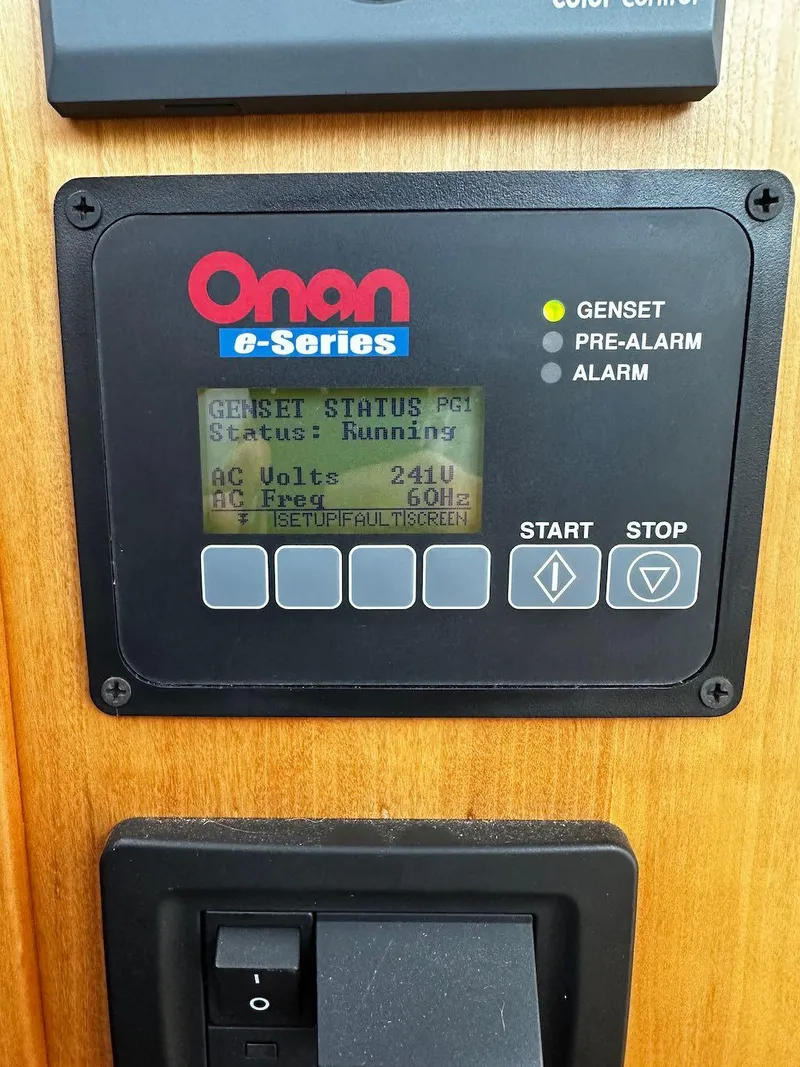Slide: The Image of Onan e-Series generator control panel displaying status and voltage on a 2008 Sabre 42 Hard Top Express. - 24