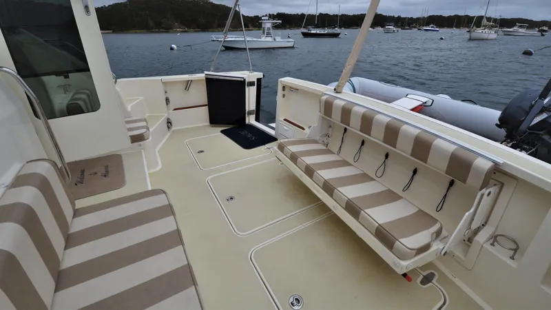 Slide: The Image of 2008 Sabre 42 Hard Top Express boat interior with striped seating, docked by the water. - 28