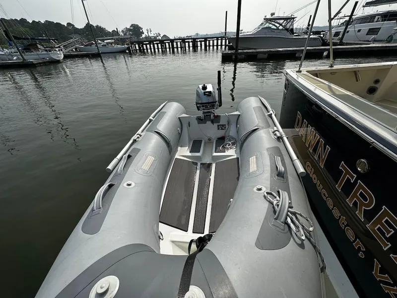 Slide: The Image of Inflatable boat docked near Sabre 42 Hard Top Express, 2008 model, in a marina. - 34