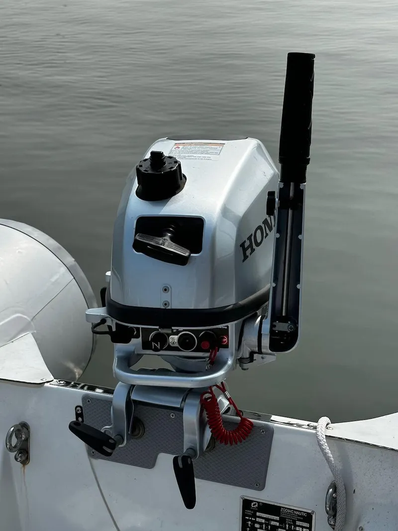 Slide: The Image of Outboard motor on a 2008 Sabre 42 Hard Top Express boat, docked on calm water. - 35