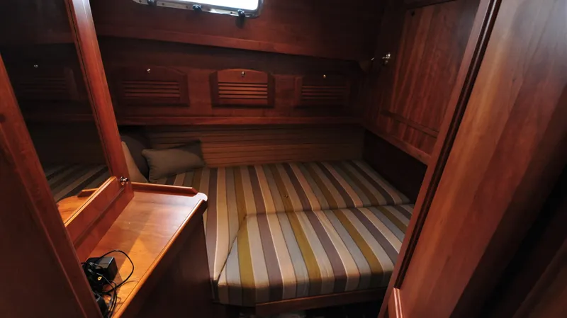 Slide: The Image of 2008 Sabre 42 Hard Top Express cabin with striped bedding and wooden interior. - 39