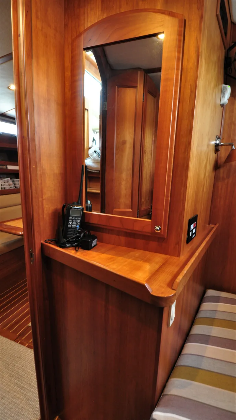 Slide: The Image of 2008 Sabre 42 Hard Top Express interior with wooden cabinetry and mirror. - 40