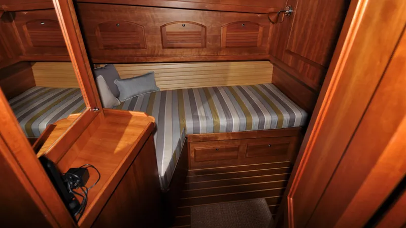 Slide: The Image of 2008 Sabre 42 Hard Top Express cabin with wooden interior and striped bedding. - 41