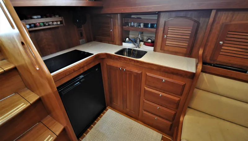 Slide: The Image of 2008 Sabre 42 Hard Top Express yacht interior kitchen with wooden cabinetry and modern appliances. - 45