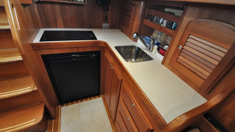 Slide: The Image of 2008 Sabre 42 Hard Top Express yacht kitchen with wood cabinetry and modern appliances. - 46
