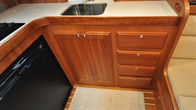 Slide: The Image of 2008 Sabre 42 Hard Top Express galley with wood cabinetry and stainless steel sink. - 49