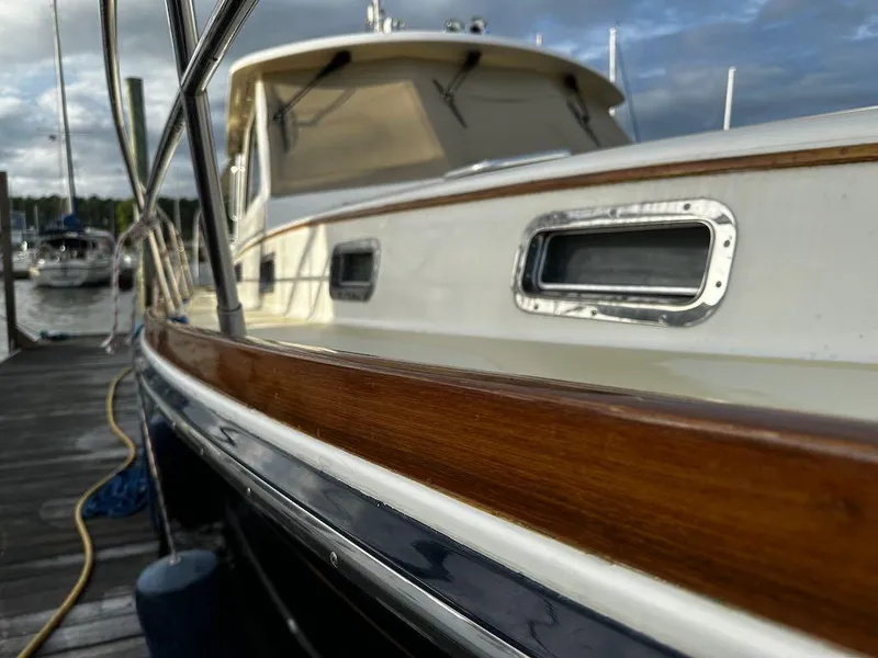 Slide: The Image of 2008 Sabre 42 Hard Top Express yacht docked, showcasing sleek design and polished wood finish. - 5