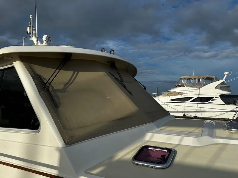 Slide: The Image of 2008 Sabre 42 Hard Top Express yacht docked under cloudy skies. - 6