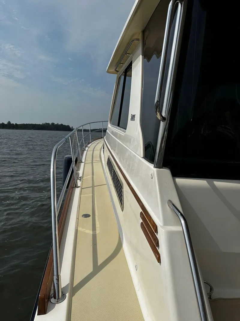 Slide: The Image of 2008 Sabre 42 Hard Top Express yacht on calm waters, side view. - 8