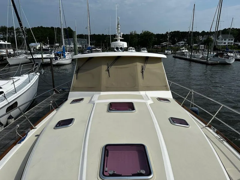 Slide: The Image of 2008 Sabre 42 Hard Top Express yacht docked in a marina with sailboats. - 9