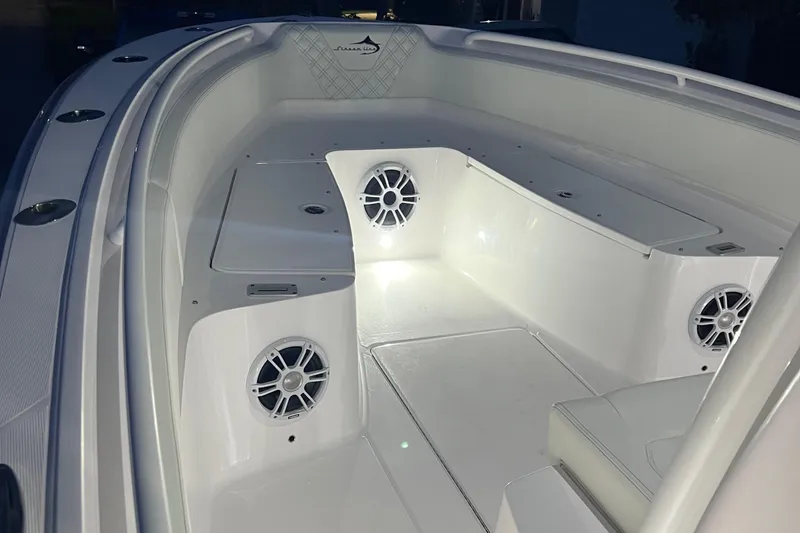 Slide: The Image of 2022 Streamline 26TE boat interior with illuminated speakers and seating area. - 10