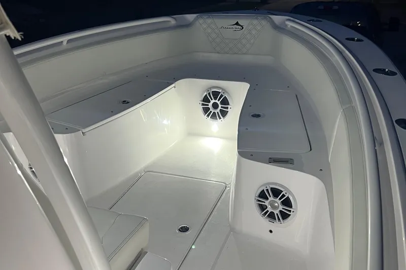 Slide: The Image of 2022 Streamline 26TE boat interior with illuminated speakers and seating area. - 11