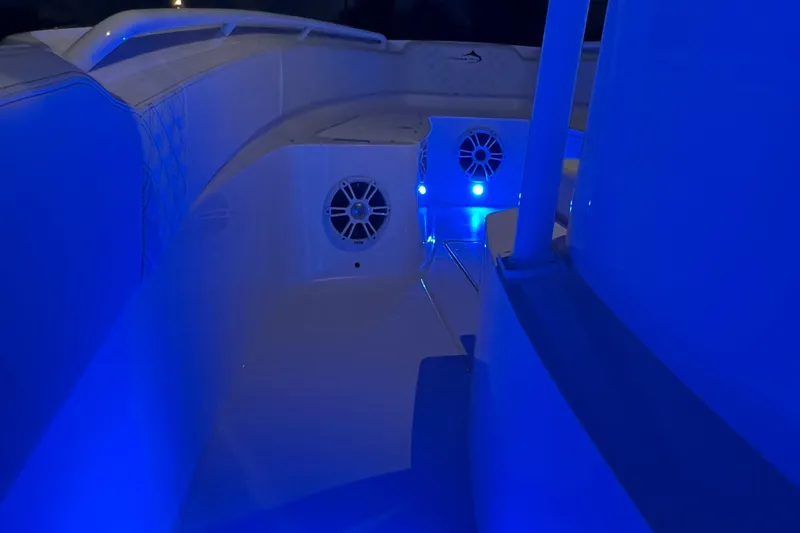 Slide: The Image of 2022 Streamline 26TE boat interior with blue LED lighting at night. - 13