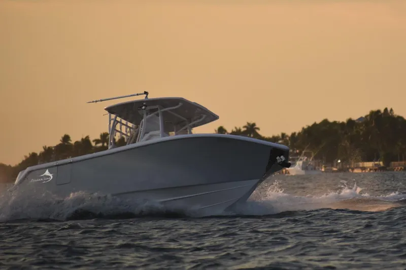Slide: The Image of Streamline 26TE 2022 boat cruising at sunset on the water. - 2