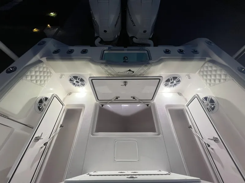 Slide: The Image of 2022 Streamline 26TE boat interior with illuminated storage compartments and twin outboard motors. - 5