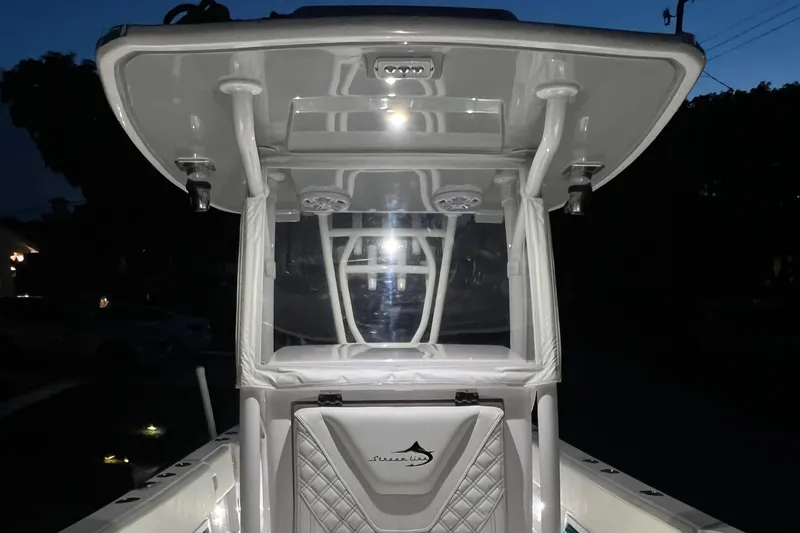 Slide: The Image of 2022 Streamline 26TE boat console illuminated at night. - 8