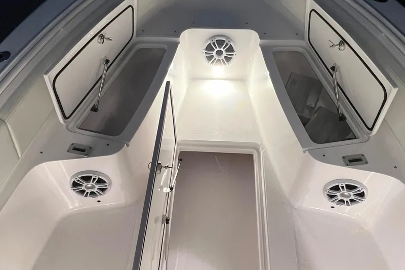 Slide: The Image of 2022 Streamline 26TE boat interior with storage compartments and speakers. - 9