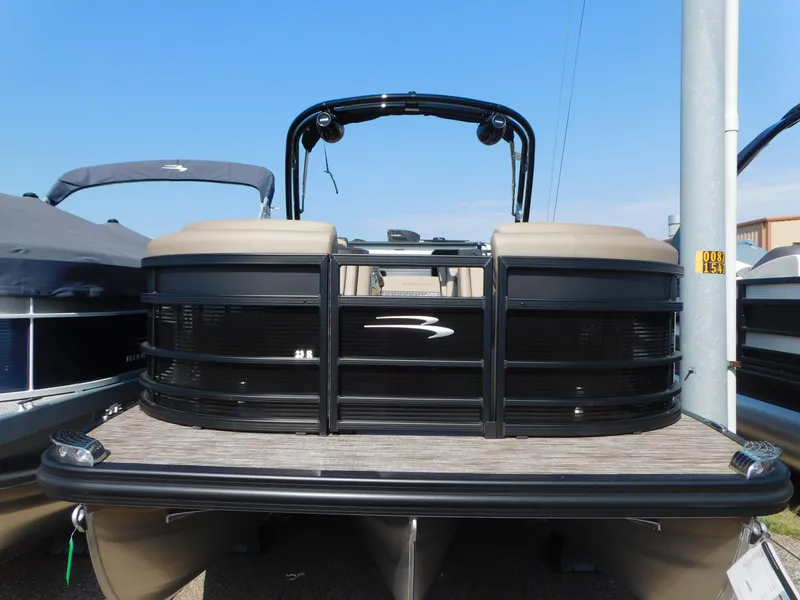 Slide: The Image of 2023 Bennington 23RSBA pontoon boat, front view, docked under clear blue sky. - 2