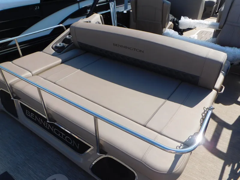 Slide: The Image of 2023 Bennington 23RSBA pontoon boat with beige seating and sleek design. - 4