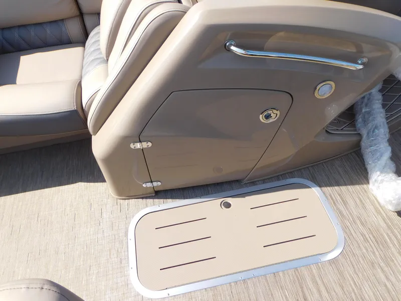 Slide: The Image of Bennington 23RSBA 2023 boat interior with beige seating and storage compartment. - 7