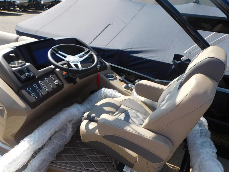 Slide: The Image of 2023 Bennington 23RSBA boat cockpit with steering wheel and captain's chair. - 9