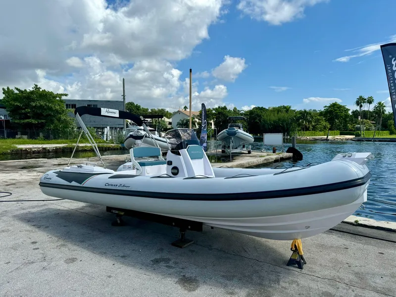 The Image of 2023 Ranieri CAYMAN 21 SPORT boat docked by a scenic waterfront. - 0