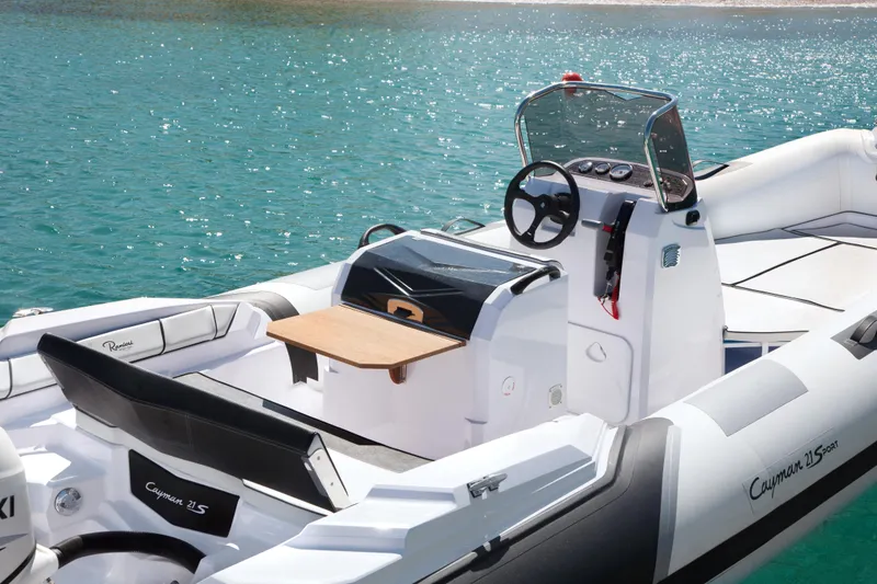 Slide: The Image of 2023 Ranieri CAYMAN 21 SPORT boat on clear blue water. - 12