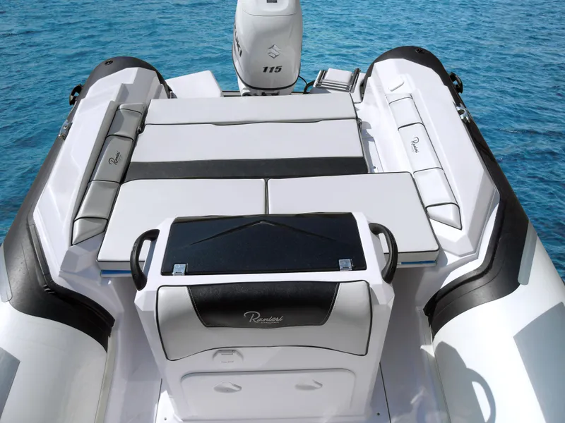 Slide: The Image of 2023 Ranieri CAYMAN 21 SPORT boat interior with seating and outboard motor. - 15