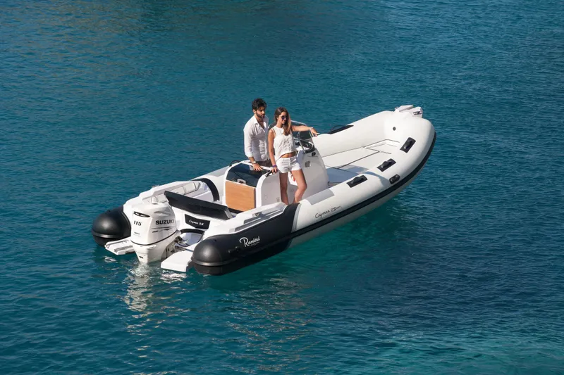 Slide: The Image of 2023 Ranieri CAYMAN 21 SPORT boat on clear blue water. - 3