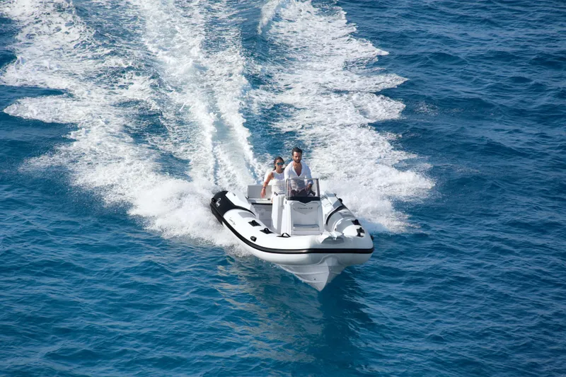 Slide: The Image of 2023 Ranieri CAYMAN 21 SPORT boat cruising on blue ocean water. - 8