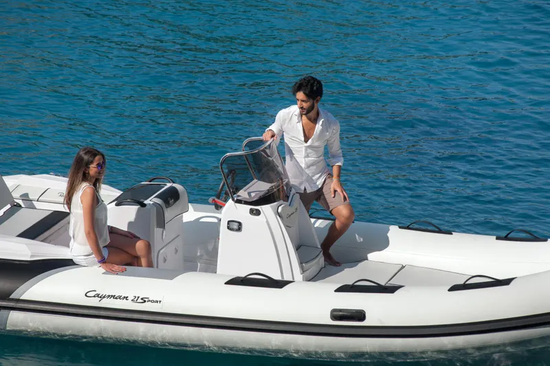 Slide: The Image of 2023 Ranieri CAYMAN 21 SPORT inflatable boat on water with two people onboard. - 9